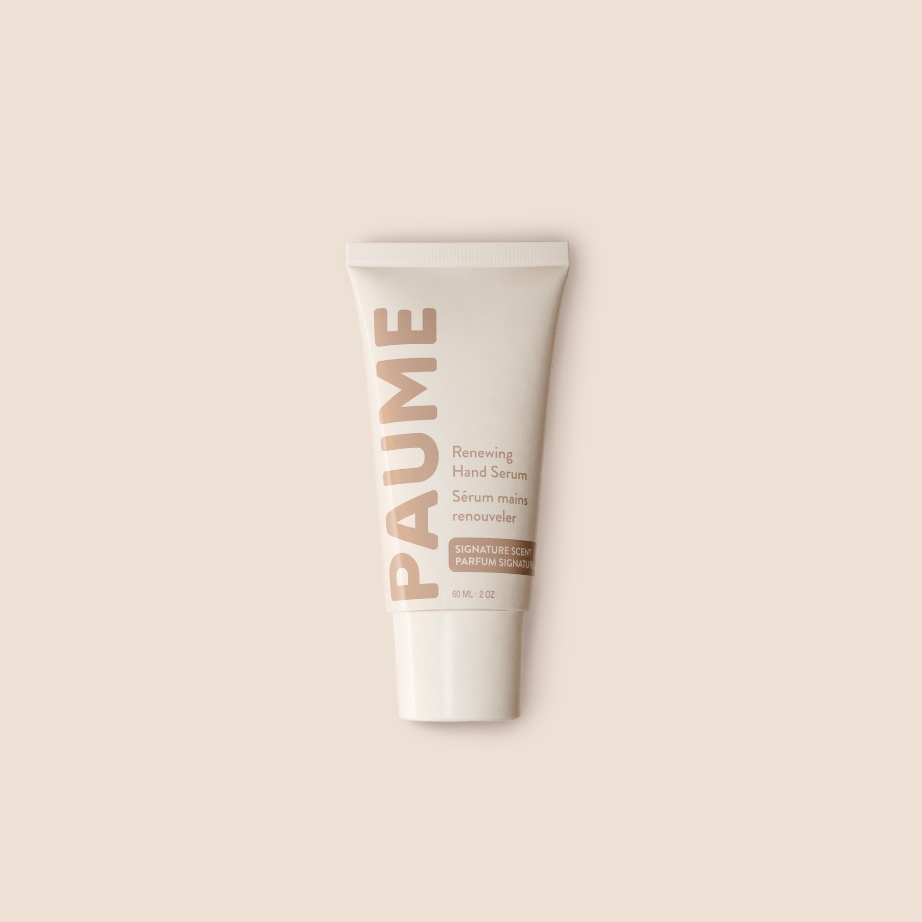 PAUME anti-aging hand serum tube on a beige background