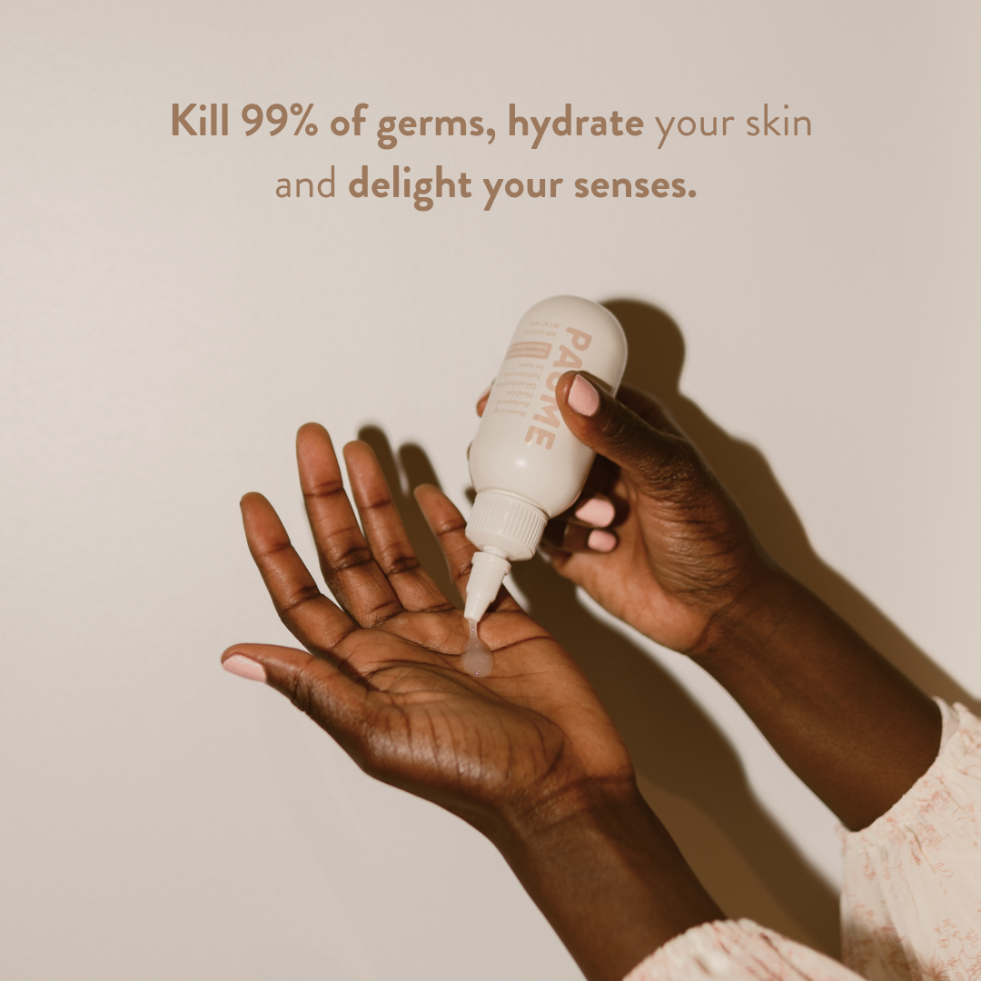 Hand holding a bottle of skincare product with text on a plain background