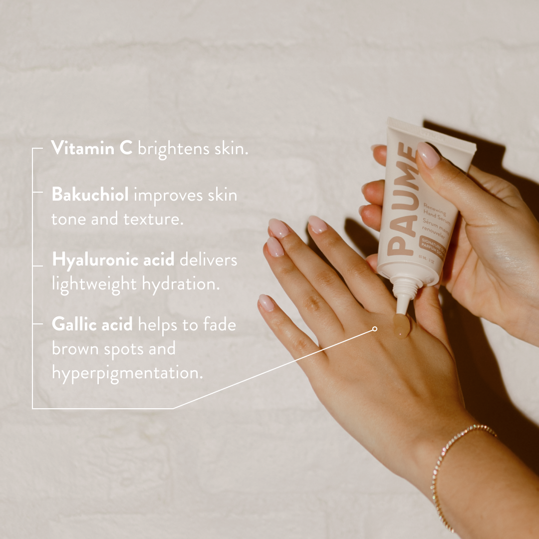 Hand applying PAUME anti-aging hand serum skincare product with text about skin benefits on a neutral background